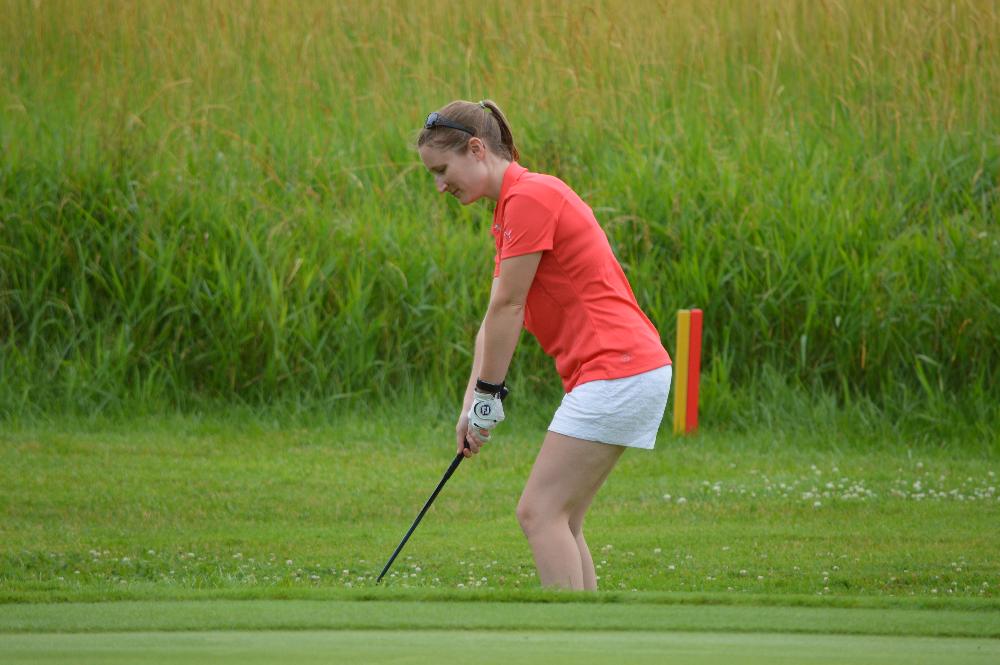 An alumna golfing on The Meadows Golf Course.
